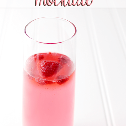 Drink Pink Mocktail in a glass with fresh strawberries.