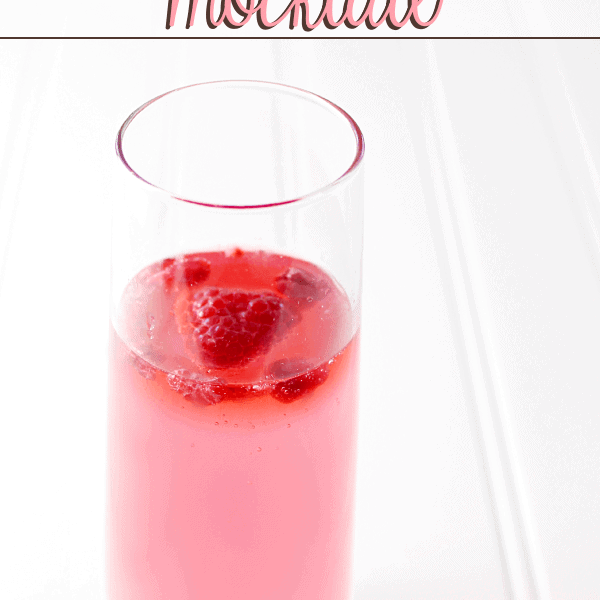 Drink Pink Mocktail in a glass with fresh strawberries.