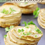 Garlic Parmesan Parslied Potato Stacks on a cutting board.