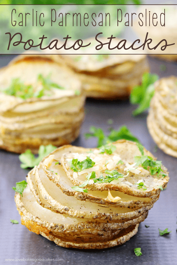 Garlic Parmesan Parslied Potato Stacks on a cutting board.