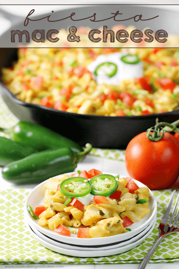 Fiesta Mac & Cheese on a white plate with a skillet and fresh vegetables.