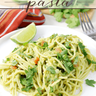 Guacamole Pasta on a white plate with a fork.
