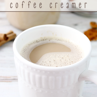 A cup of coffee in a white cup showing the top of the cup.