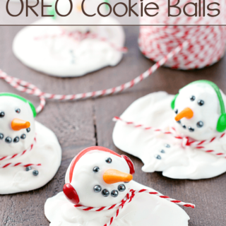 Melting Snowman OREO Cookie Balls laying on a cutting board.