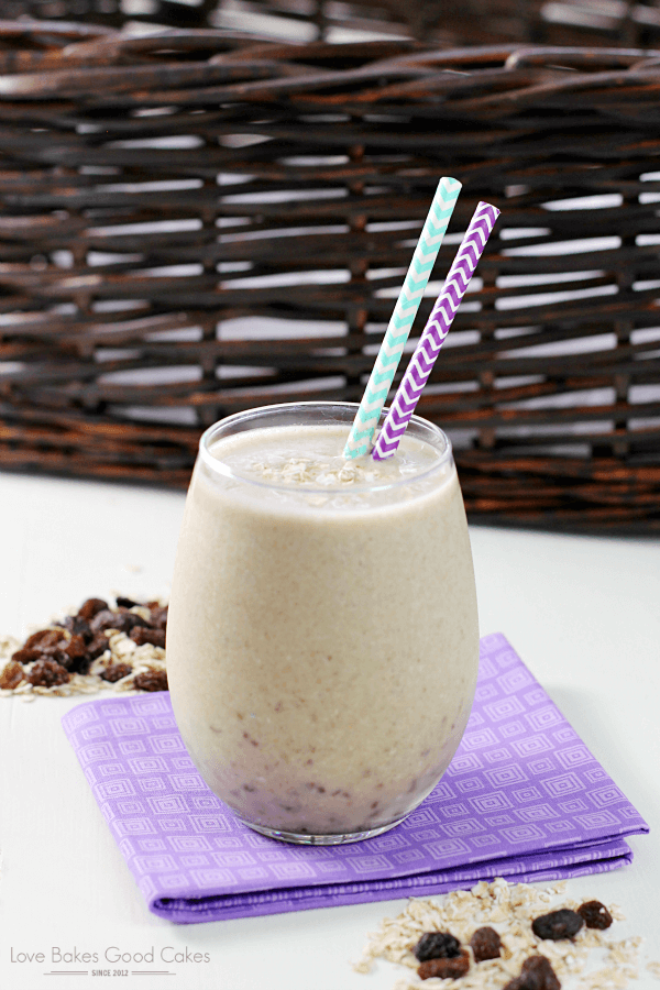 Banana Bread Smoothie in a glass with two straws.