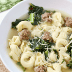 Italian Tortellini Soup in a white bowl.
