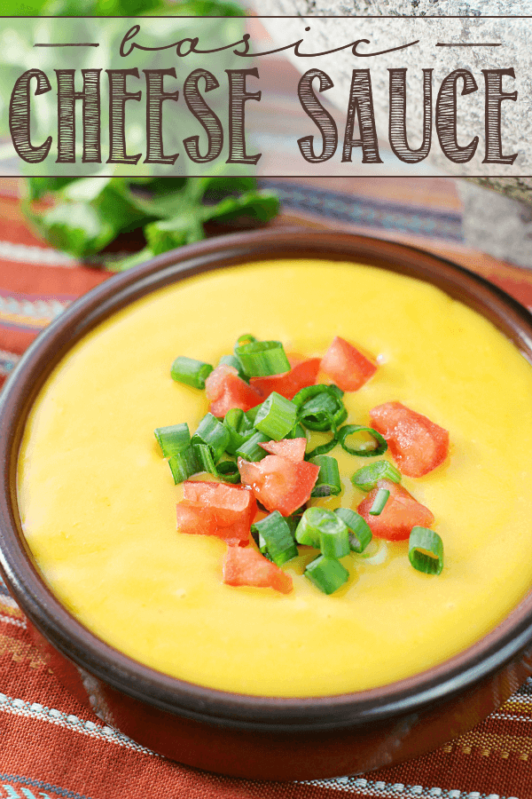 Basic Cheese Sauce in a brown bowl with fresh vegetables.