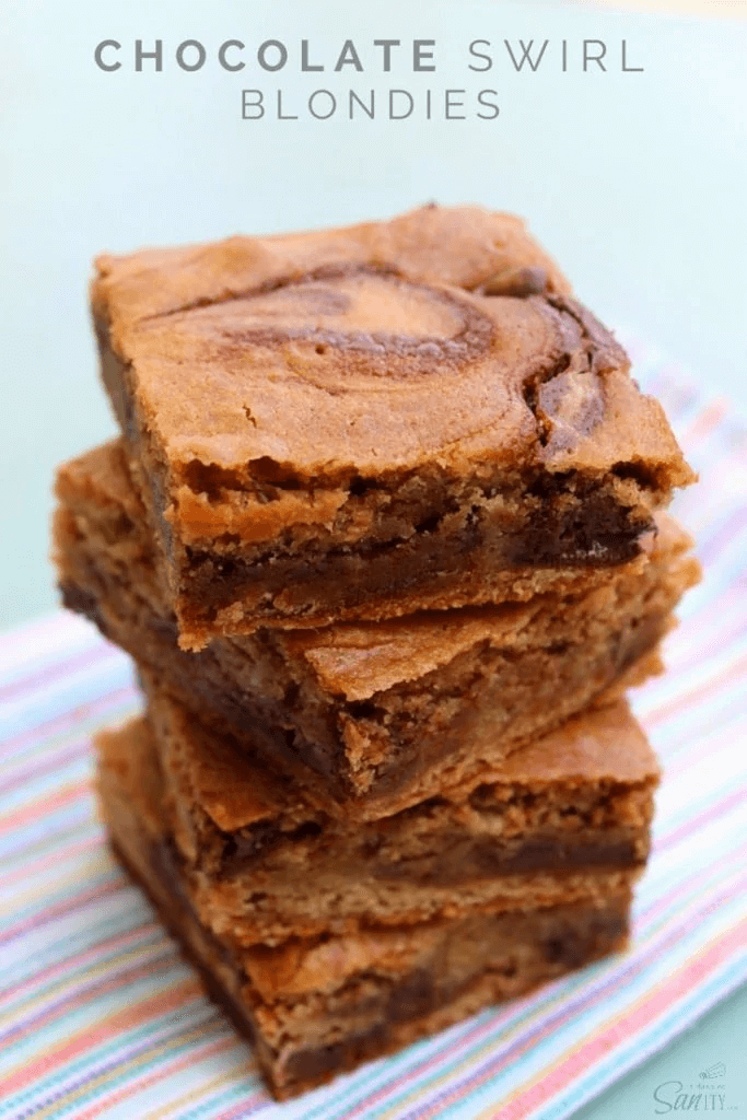 Chocolate Swirl Blondies cut into squares on a cutting board.