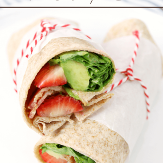 Bacon, Avocado & Strawberry Wraps stacked on a plate.