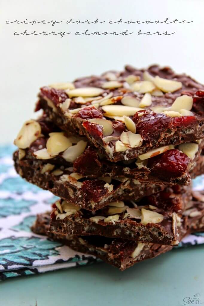 Crispy Dark Chocolate Cherry & Almond Bars stacked on a napkin.