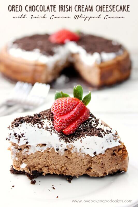 Oreo Chocolate Irish Cream Cheesecake with Irish Cream Whipped Cream close up on a white plate.