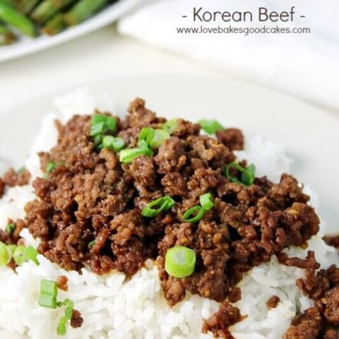 Korean Beef on a white plate with diced green onions.