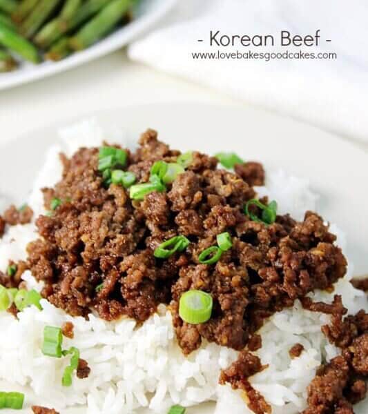 Korean Beef on a white plate with diced green onions.