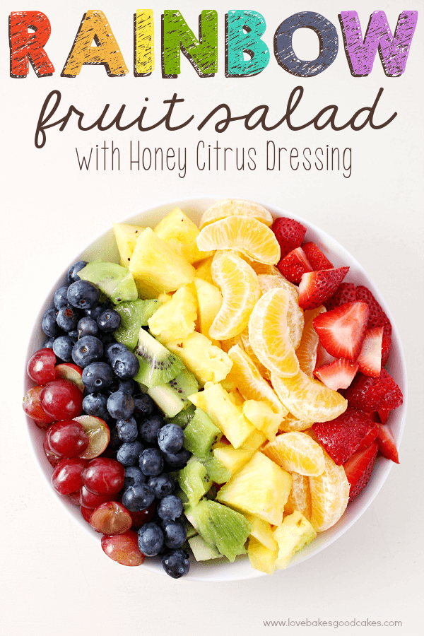 Rainbow Fruit Salad with Honey Citrus Dressing in a white bowl.