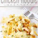 Cheesy Chicken Noodle Casserole on a white plate with a fork.