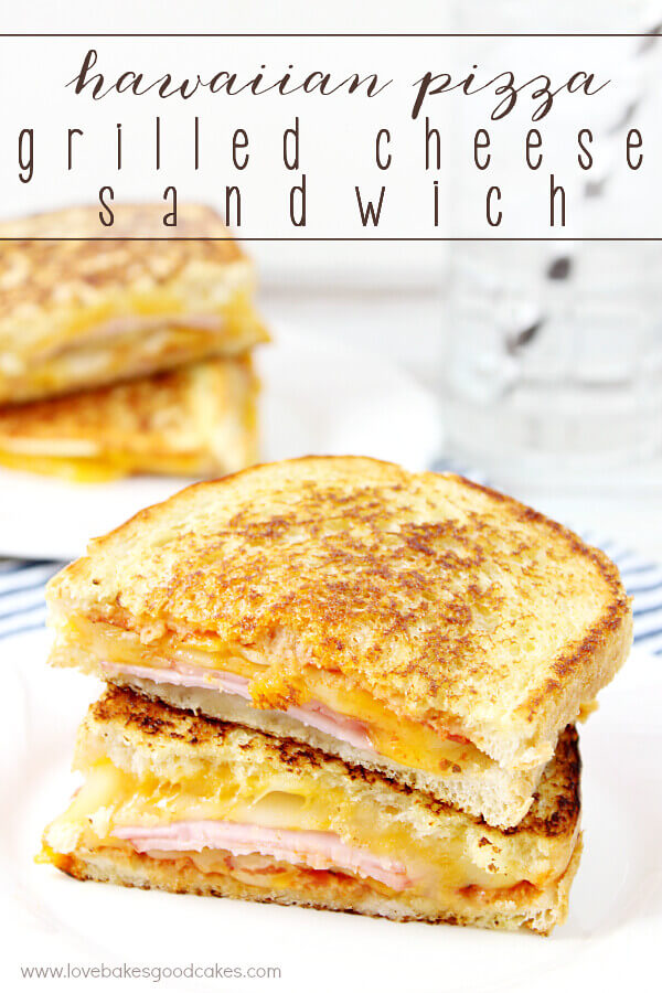 Hawaiian Pizza Grilled Cheese Sandwich sliced in half, and stacked on a white plate.