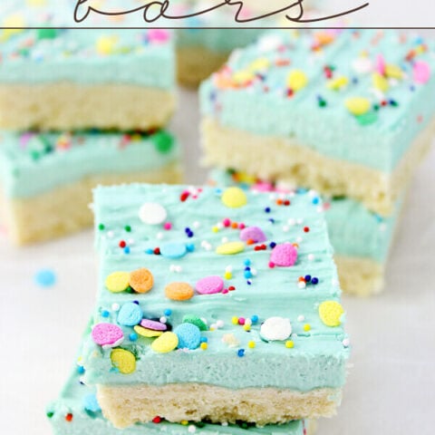 Sugar Cookie Bars stacked on parchment paper.