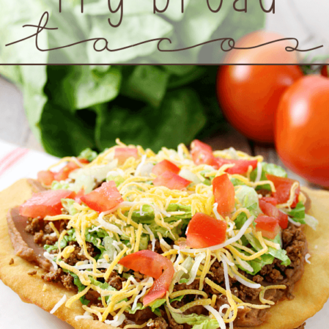 Fry Bread Taco on a white plate with fresh vegetables.