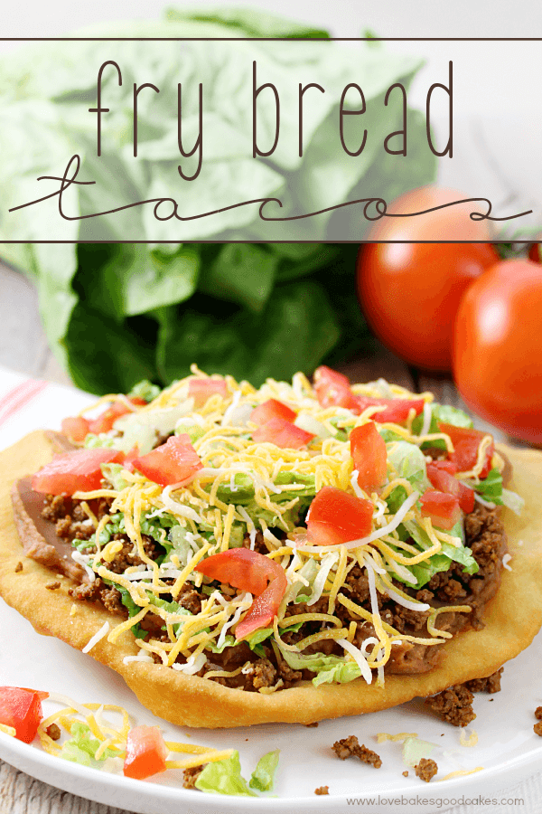 Fry Bread Taco on a white plate with fresh vegetables.