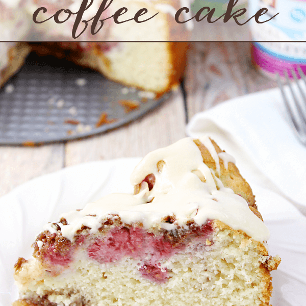 Raspberry Pecan Coffee Cake on a white plate with a fork.