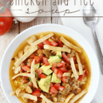 Mexican Chicken and Rice Soup in a white bowl with a spoon.
