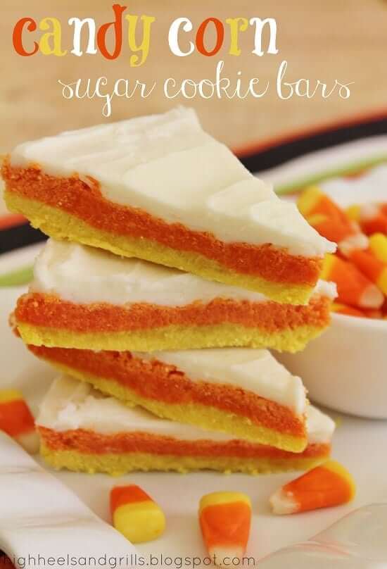 Candy corn sugar cookie bars stacked on a white plate.