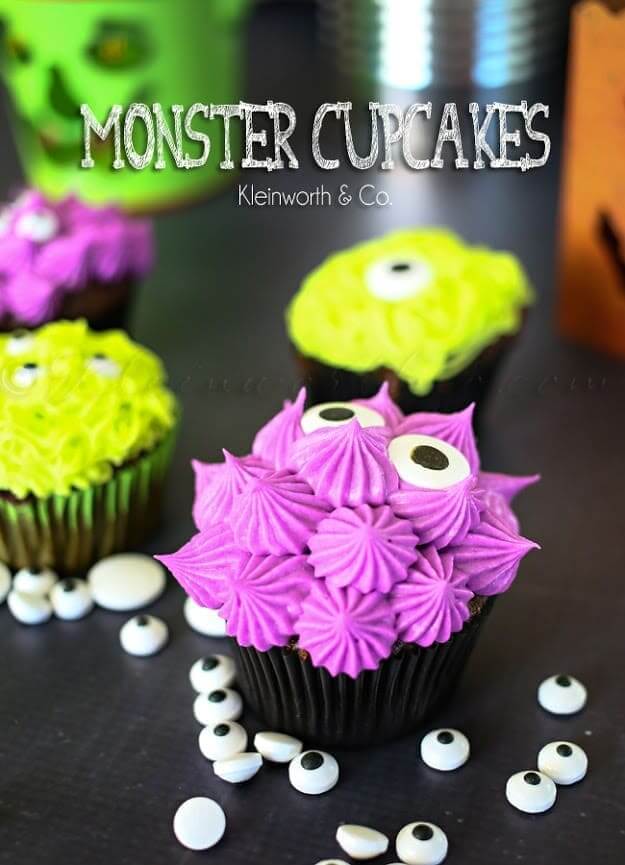 Monster cupcakes laying on a table.