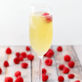 Mock Champagne Punch in a glass with fresh strawberries.