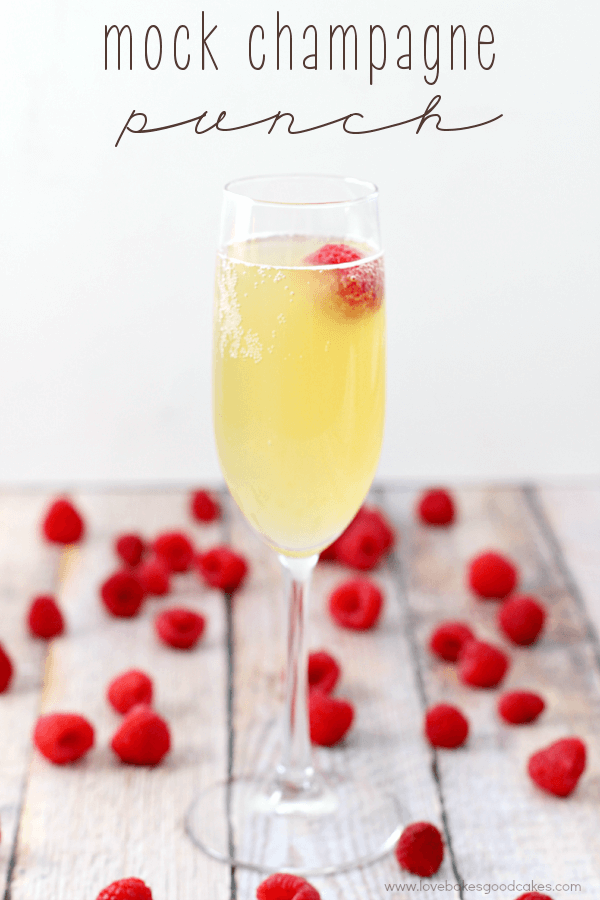 Mock Champagne Punch in a glass with fresh strawberries.