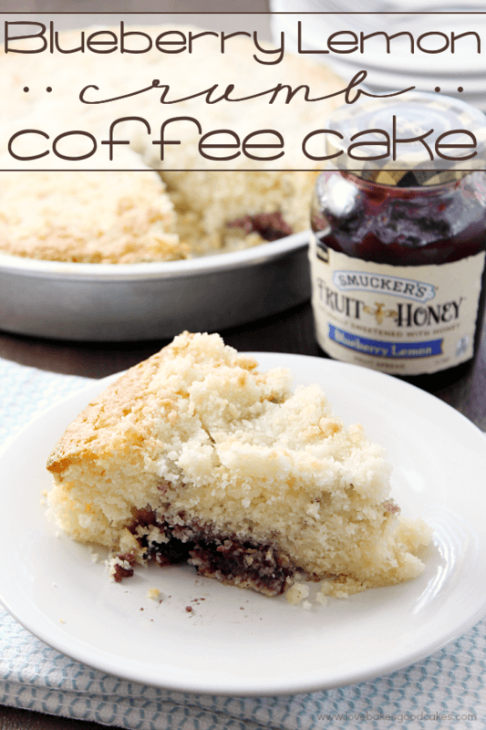 Blueberry Lemon Crumb Coffee Cake on a white plate with a jar of jam.