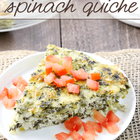 Crustless Spinach Quiche on a white plate with fresh tomatoes.