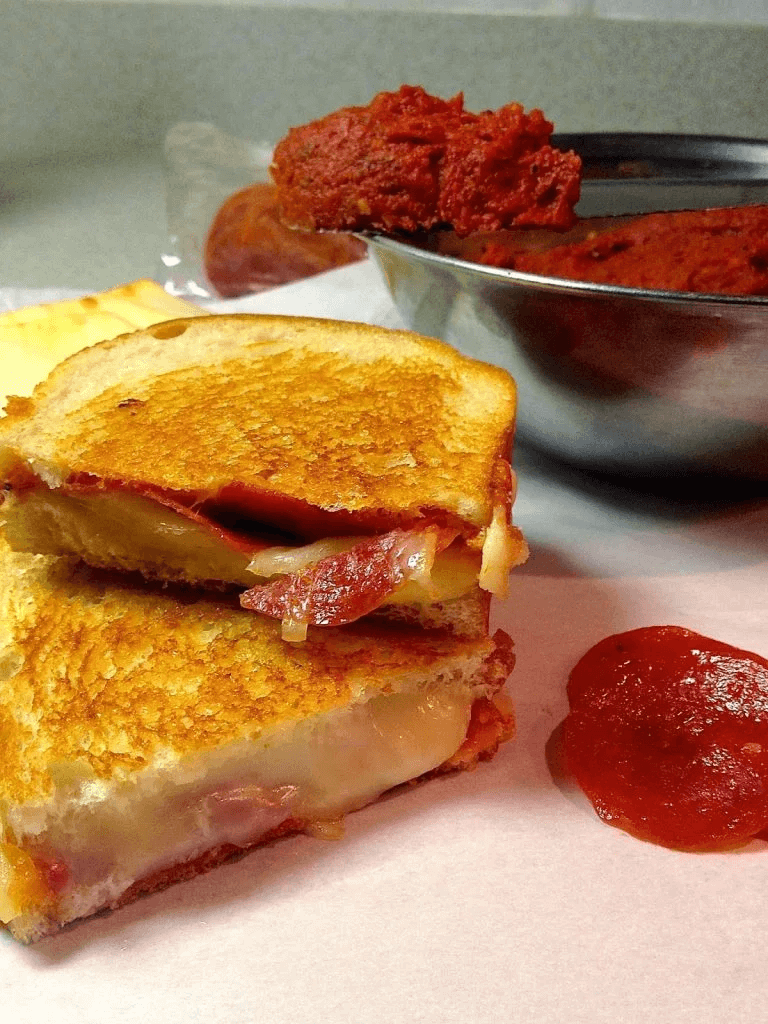 Pepperoni Pizza Grilled Cheese with Pizza Butter on a plate close up.