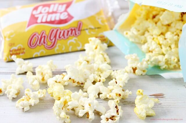 Jolly Time Oh Yum popcorn laying on a cutting board.