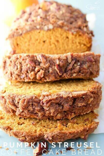 Pumpkin streusel bread sliced open on a cutting board.