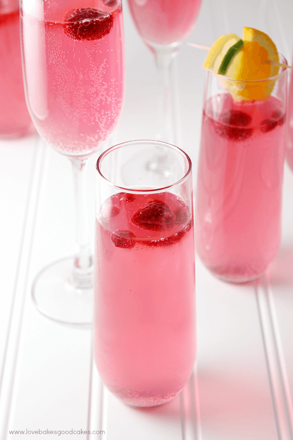 Drink Pink Mocktail in a glass with fresh strawberries.