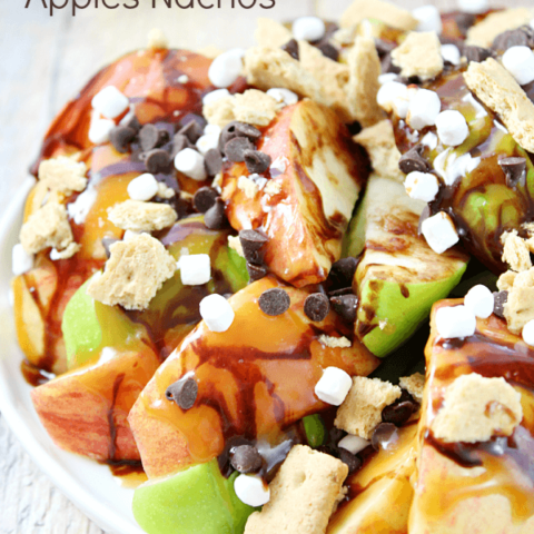 S'mores Salted Caramel Apple Nachos on a plate with fresh apples.