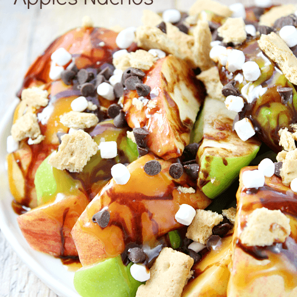 S'mores Salted Caramel Apple Nachos on a plate with fresh apples.