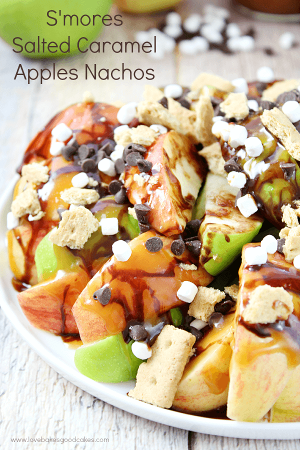 S'mores Salted Caramel Apple Nachos on a plate with fresh apples.