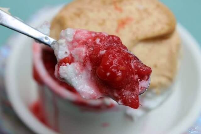 Raspberry Meringue Soufflé in a white bowl with a spoon.