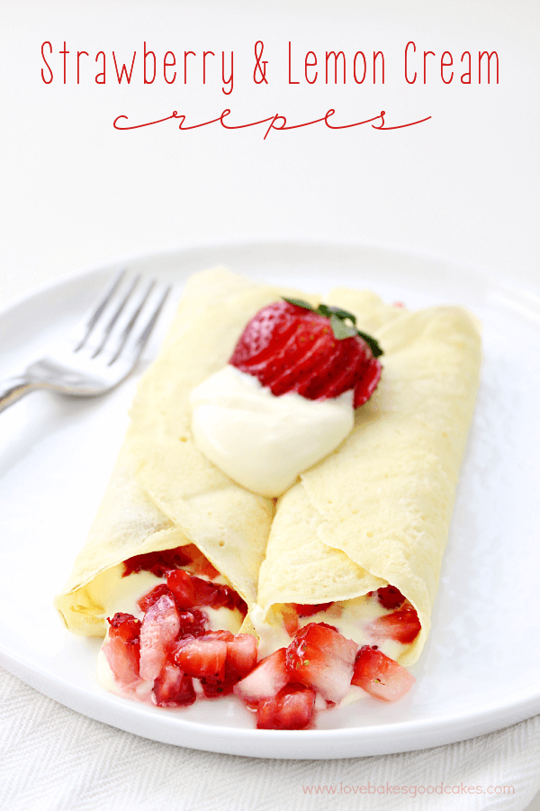 Strawberry & lemon cream crepes on a white plate with a fork.