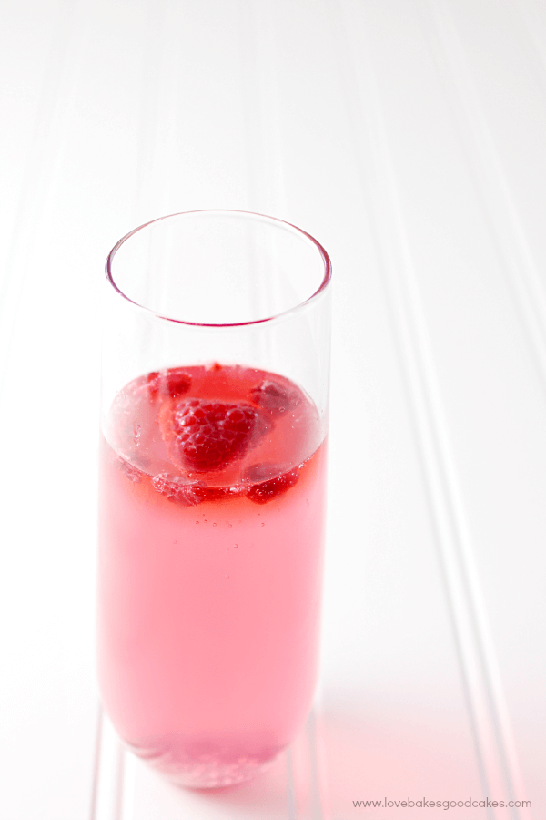 Drink Pink Mocktail in a glass with fresh strawberries.