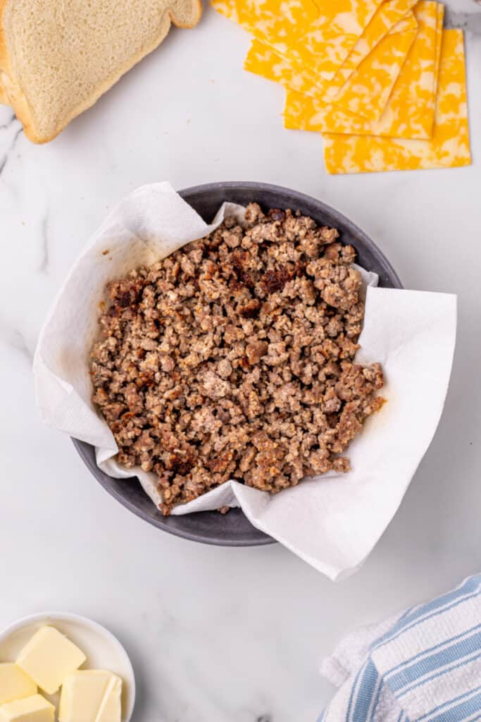 Cooked sausage in a bowl for a Breakfast Grilled Cheese sandwich recipe