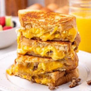 Breakfast grilled cheese recipe on sourdough bread with melted cheese, eggs, and sausage