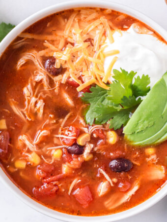 closeup of enchilada soup in white bowl