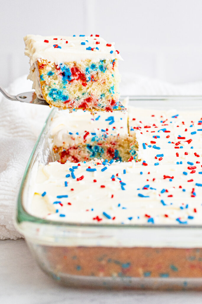 taking a slice of cake out of the baking dish