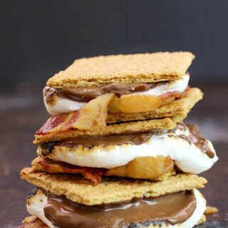 Bacon S'mores stacked up on a cutting board.