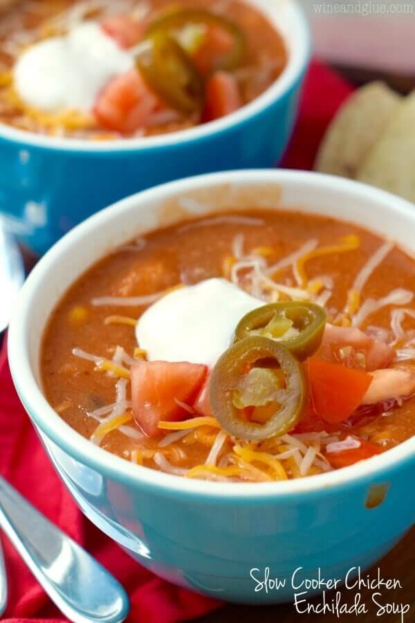 Slow cooker chicken enchilada soup in a blue bowl.