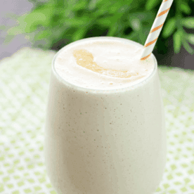 Peach & Oatmeal Smoothie in a glass with a straw.