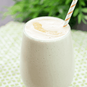 Peach & Oatmeal Smoothie in a glass with a straw.