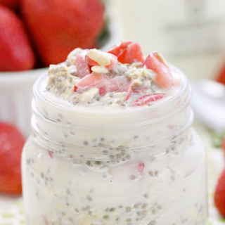 Strawberry Vanilla Overnight Oatmeal in a jar with fresh strawberries.